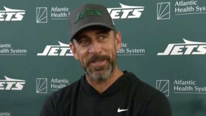 New York Jets quarterback Aaron Rodgers answers a question from teammate Breece Hall during a media session on Wednesday. 