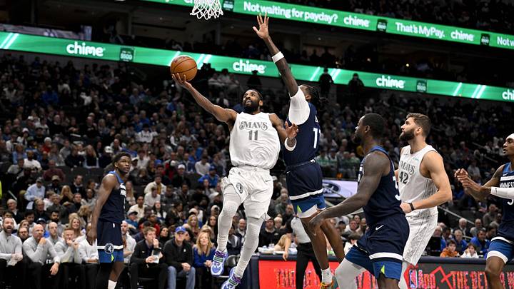 Jan 22, 2025; Dallas, Texas, USA; Dallas Mavericks guard Kyrie Irving (11) drives to the basket past Minnesota Timberwolves center Naz Reid (11) during the second half at the American Airlines Center. Mandatory Credit: Jerome Miron-Imagn Images Jan 22, 2025; Dallas, Texas, USA; Dallas Mavericks guard Kyrie Irving (11) drives to the basket past Minnesota Timberwolves center Naz Reid (11) during the second half at the American Airlines Center. Mandatory Credit: Jerome Miron-Imagn Images