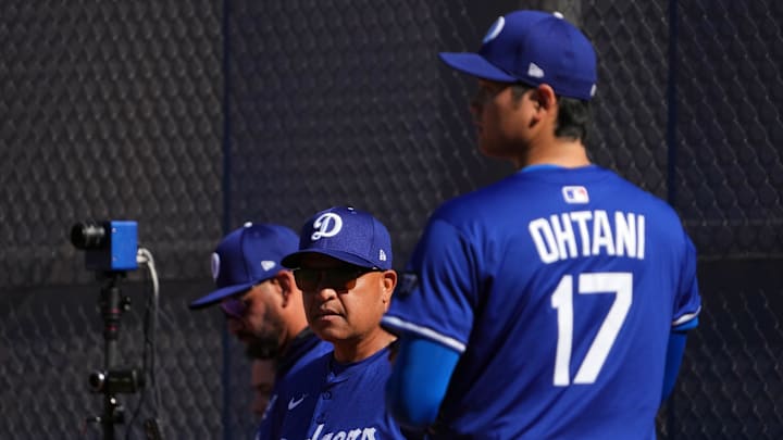 Los Angeles Dodgers manager Dave Roberts (30) watches Los Angeles Dodgers two-way player Shohei Ohtani (17) throw during a Spring Training workout at Camelback Ranch on Feb. 15.