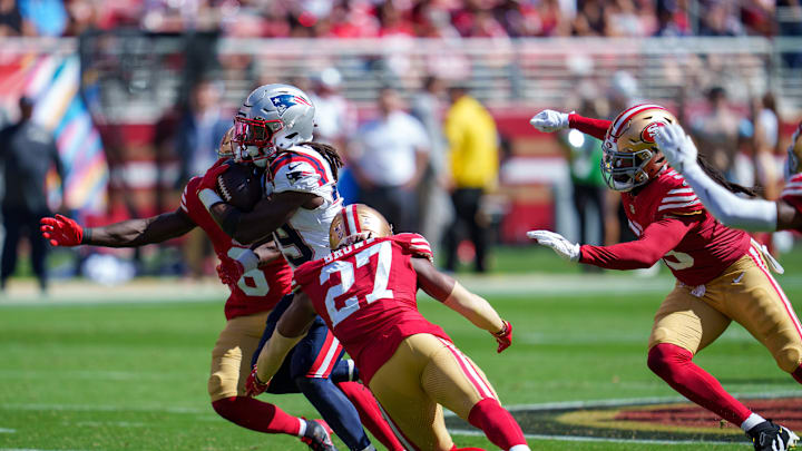 Sep 29, 2024; Santa Clara, California, USA; New England Patriots running back JaMycal Hasty (39) is tackled by San Francisco 49ers safety Ji'Ayir Brown (27) and safety Malik Mustapha (6) during the second quarter at Levi's Stadium. Mandatory Credit: Neville E. Guard-Imagn Images