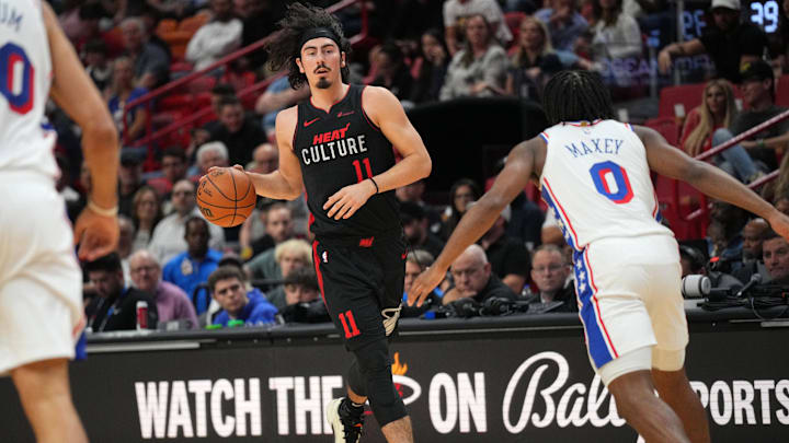 Apr 4, 2024; Miami, Florida, USA;  Miami Heat guard Jaime Jaquez Jr. (11) brings the ball up the court as Philadelphia 76ers guard Tyrese Maxey (0) defends during the first half at Kaseya Center. Mandatory Credit: Jim Rassol-Imagn Images