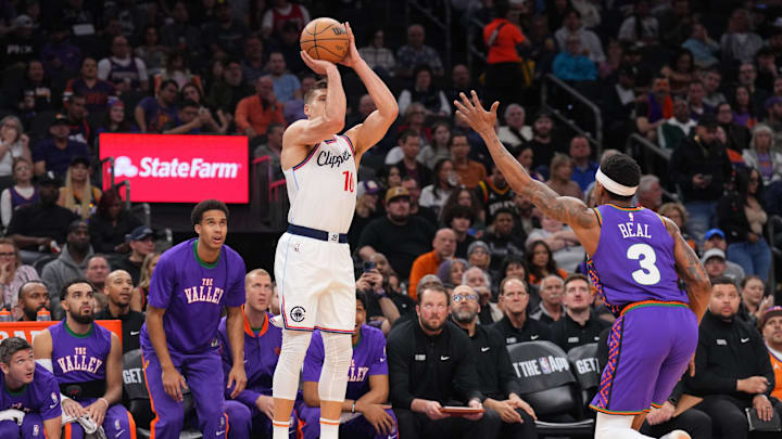 Mar 4, 2025; Phoenix, Arizona, USA; LA Clippers guard Bogdan Bogdanovic (10) shoots against Phoenix Suns guard Bradley Beal (3) during the first half at PHX Center. Mandatory Credit: Joe Camporeale-Imagn Images