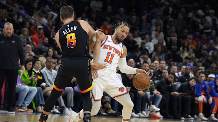 Dec 15, 2023; Phoenix, Arizona, USA; New York Knicks guard Jalen Brunson (11) drives on Phoenix Suns guard Grayson Allen (8) in the second half at Footprint Center. Mandatory Credit: Rick Scuteri-Imagn Images