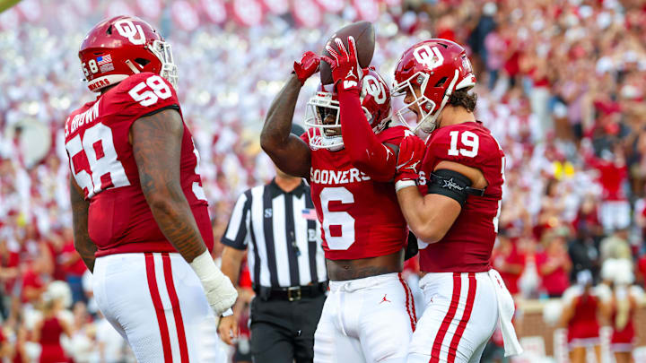 Aug 30, 2024; Norman, Oklahoma, USA; Oklahoma Sooners wide receiver Deion Burks (6) celebrates with Oklahoma Sooners tight end Kade McIntyre (19) and Oklahoma Sooners offensive lineman Spencer Brown (58) after scoring during the first quarter against the Temple Owls at Gaylord Family-Oklahoma Memorial Stadium. Mandatory Credit: Kevin Jairaj-Imagn Images Aug 30, 2024; Norman, Oklahoma, USA; Oklahoma Sooners wide receiver Deion Burks (6) celebrates with Oklahoma Sooners tight end Kade McIntyre (19) and Oklahoma Sooners offensive lineman Spencer Brown (58) after scoring during the first quarter against the Temple Owls at Gaylord Family-Oklahoma Memorial Stadium. Mandatory Credit: Kevin Jairaj-Imagn Images