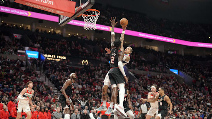 Dec 21, 2023; Portland, Oregon, USA; Washington Wizards small forward Kyle Kuzma (33, behind) shoots the ball over Portland Trail Blazers center Deandre Anton (2) during the first half at Moda Center. Mandatory Credit: Soobum Im-Imagn Images