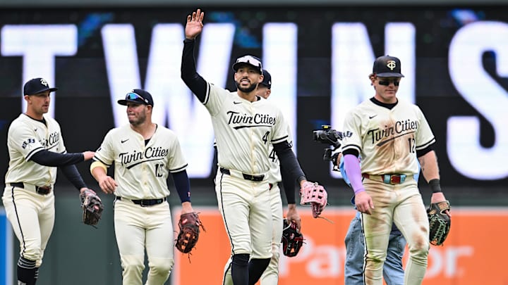 Apr 27, 2025; Minneapolis, Minnesota, USA; Minnesota Twins shortstop Carlos Correa (4) reacts to the crowd with outfielder Harrison Bader (12) and teammates after the game against the Los Angeles Angels at Target Field. Mandatory Credit: Jeffrey Becker-Imagn Images