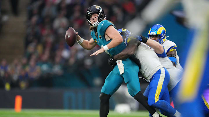 Oct 19, 2025; London, United Kingdom; Los Angeles Rams linebacker Bryon Young (0) tackles Jacksonville Jaguars quarterback Trevor Lawrence (16) during the second half of an NFL International Series game at Wembley Stadium. Mandatory Credit: Kirby Lee-Imagn Images Oct 19, 2025; London, United Kingdom; Los Angeles Rams linebacker Bryon Young (0) tackles Jacksonville Jaguars quarterback Trevor Lawrence (16) during the second half of an NFL International Series game at Wembley Stadium. Mandatory Credit: Kirby Lee-Imagn Images