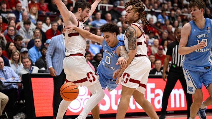 Jan 14, 2026; Stanford, California, USA; North Carolina Tar Heels guard Kyan Evans (0) looses control of the ball while dribbling against Stanford Cardinal guard Jeremy Dent-Smith (25) and forward AJ Rohosy (4) in the second half at Maples Pavilion. Mandatory Credit: Eakin Howard-Imagn Images