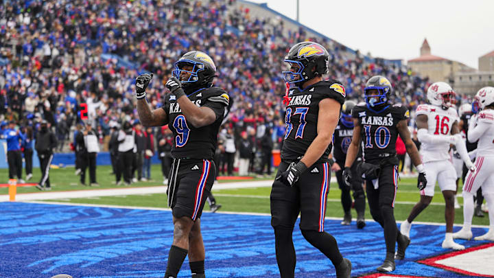 Nov 28, 2025; Lawrence, Kansas, USA; Kansas Jayhawks running back Daniel Hishaw Jr. (9) celebrates after scoring a touchdown during the first half against the Utah Utes at David Booth Kansas Memorial Stadium. Mandatory Credit: Jay Biggerstaff-Imagn Images