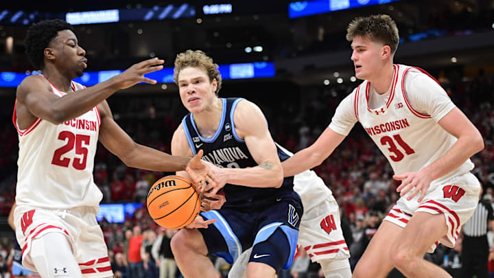 Dec 19, 2025; Milwaukee, Wisconsin, USA; Villanova Wildcats forward Matt Hodge (33) gets pressure from Wisconsin Badgers guard John Blackwell (25) and forward Nolan Winter (31) in the second half at the Fiserv Forum. Mandatory Credit: Benny Sieu-Imagn Images Dec 19, 2025; Milwaukee, Wisconsin, USA; Villanova Wildcats forward Matt Hodge (33) gets pressure from Wisconsin Badgers guard John Blackwell (25) and forward Nolan Winter (31) in the second half at the Fiserv Forum. Mandatory Credit: Benny Sieu-Imagn Images