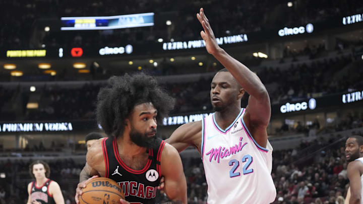 Apr 9, 2025; Chicago, Illinois, USA; Miami Heat forward Andrew Wiggins (22) defends Chicago Bulls guard Coby White (0) during the first quarter at United Center. Mandatory Credit: David Banks-Imagn Images