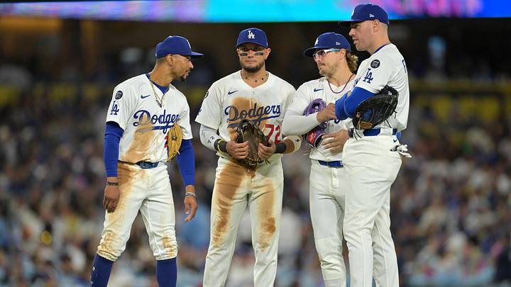 Sep 10, 2025; Los Angeles, California, USA;  Los Angeles Dodgers shortstop Mookie Betts (50), second baseman Miguel Rojas (72), third baseman Enrique Hernandez (8) and first baseman Freddie Freeman (5) on the field during a pitching change during the seventh inning against the Colorado Rockies at Dodger Stadium. Mandatory Credit: Jayne Kamin-Oncea-Imagn Images
