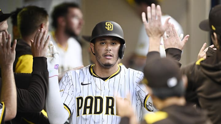 Jun 23, 2025; San Diego, California, USA; San Diego Padres third baseman Manny Machado (13) is congratulated after hitting a solo home run during the fourth inning against the Washington Nationals at Petco Park. Mandatory Credit: Denis Poroy-Imagn Images