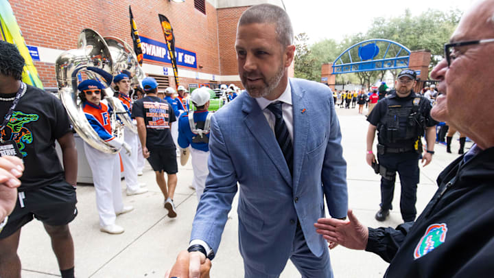 Florida Gators head coach Billy Napier shakes hands with fans during Gator Walk at Steve Spurrier