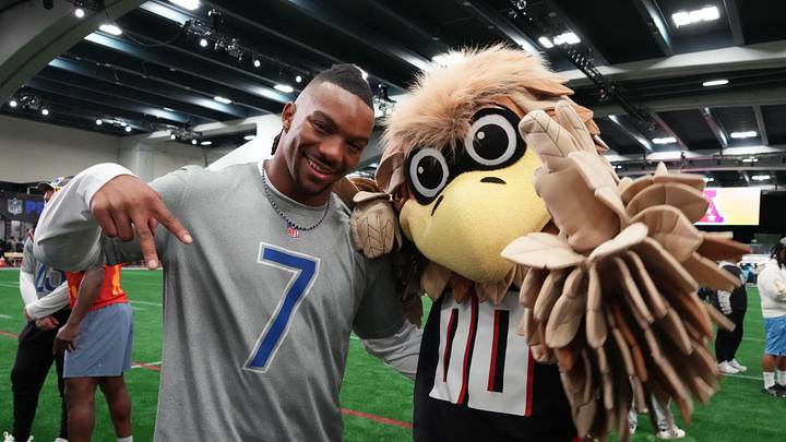 Feb 2, 2026; San Francisco, CA, USA; Atlanta Falcons running back Bijan Robinson (7) poses with Falcons mascot Freddie Falcon during NFC practice at the NFL Flag Fieldhouse at Moscone Center South Building. Mandatory Credit: Kirby Lee-Imagn Images