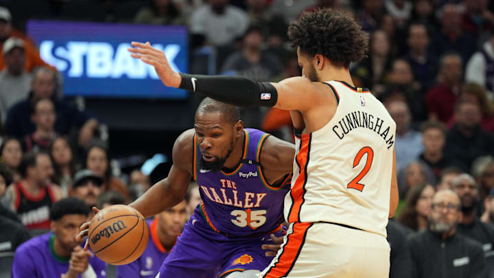 Dec 21, 2024; Phoenix, Arizona, USA; Phoenix Suns forward Kevin Durant (35) drives against Detroit Pistons guard Cade Cunningham (2) during the first half at Footprint Center. Mandatory Credit: Joe Camporeale-Imagn Images