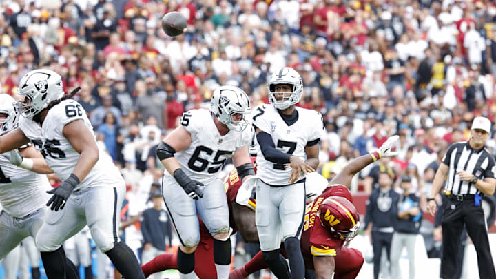 Sep 21, 2025; Landover, Maryland, USA; Las Vegas Raiders quarterback Geno Smith (7) throws a touchdown pass during the second half against the Washington Commanders at Northwest Stadium. Mandatory Credit: Amber Searls-Imagn Images