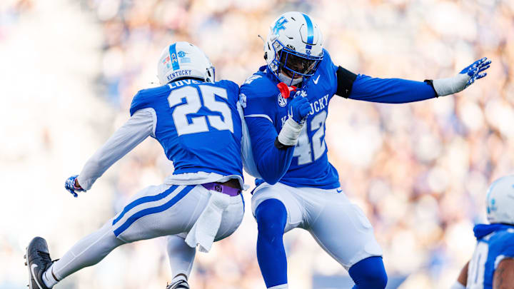 Nov 16, 2024; Lexington, Kentucky, USA; Kentucky Wildcats defensive back Jordan Lovett (25) celebrates with linebacker Tyreese Fearbry (42) after he intercepted a pass during the second quarter against the Murray State Racers at Kroger Field. Mandatory Credit: Jordan Prather-Imagn Images