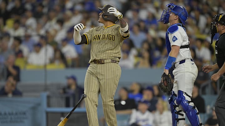 Jun 16, 2025; Los Angeles, California, USA;  San Diego Padres third baseman Manny Machado (13) flips his bat after hitting a solo home run in the sixth inning against the Los Angeles Dodgers at Dodger Stadium. Mandatory Credit: Jayne Kamin-Oncea-Imagn Images