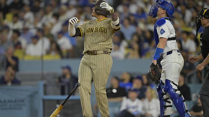Jun 16, 2025; Los Angeles, California, USA;  San Diego Padres third baseman Manny Machado (13) flips his bat after hitting a solo home run in the sixth inning against the Los Angeles Dodgers at Dodger Stadium. Mandatory Credit: Jayne Kamin-Oncea-Imagn Images