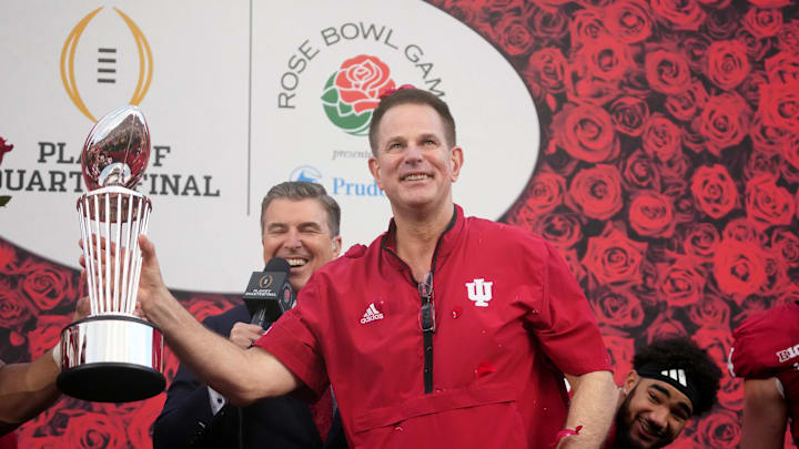 Jan 1, 2026; Pasadena, CA, USA; Indiana Hoosiers head coach Curt Cignetti celebrates with the trophy on the podium after defeating the Alabama Crimson Tide in the 2026 Rose Bowl and quarterfinal game of the College Football Playoff at Rose Bowl Stadium. Mandatory Credit: Kirby Lee-Imagn Images