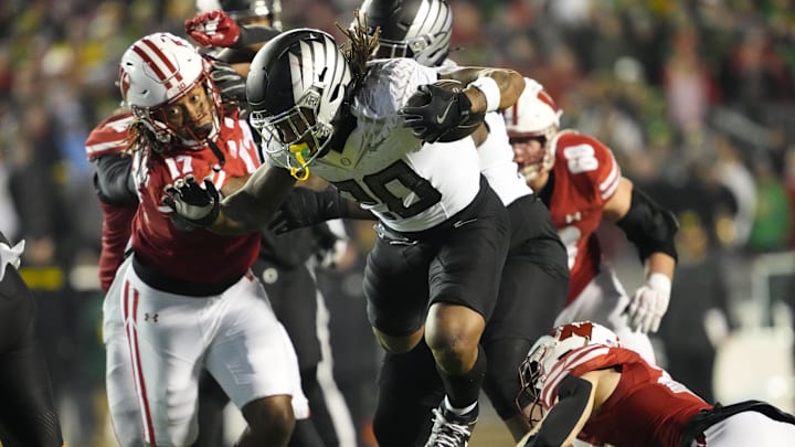 Nov 16, 2024; Madison, Wisconsin, USA;  Oregon Ducks running back Jordan James (20) rushes with the football during the fourth quarter against the Wisconsin Badgers at Camp Randall Stadium. Mandatory Credit: Jeff Hanisch-Imagn Images