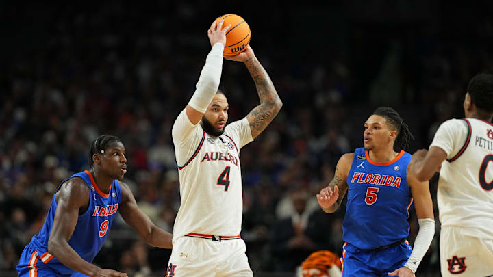 Apr 5, 2025; San Antonio, TX, USA; Auburn Tigers forward Johni Broome (4) holds the ball against the Florida Gators during the second half in the semifinals of the men's Final Four of the 2025 NCAA Tournament at the Alamodome. Mandatory Credit: Bob Donnan-Imagn Images