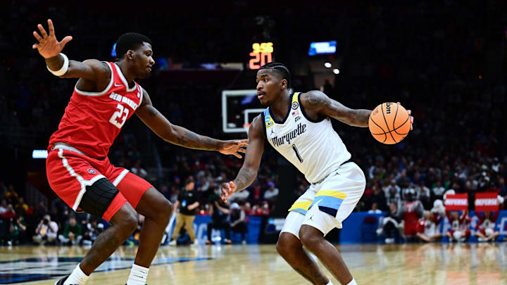 Mar 21, 2025; Cleveland, OH, USA; Marquette Golden Eagles guard Kam Jones (1) dribbles the ball defended by New Mexico Lobos center Nelly Junior Joseph (23) in the second half during the NCAA Tournament First Round at Rocket Arena. Mandatory Credit: Ken Blaze-Imagn Images Mar 21, 2025; Cleveland, OH, USA; Marquette Golden Eagles guard Kam Jones (1) dribbles the ball defended by New Mexico Lobos center Nelly Junior Joseph (23) in the second half during the NCAA Tournament First Round at Rocket Arena. Mandatory Credit: Ken Blaze-Imagn Images