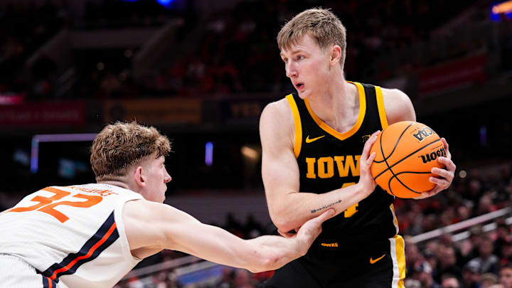 Iowa Hawkeyes guard Josh Dix (4) hesitates before rushing past Illinois Fighting Illini guard Kasparas Jakucionis (32) on Thursday, March 13, 2025, during the second round of the men's Big Ten tournament at Gainbridge Fieldhouse in Indianapolis. The Illinois Fighting Illini defeated the Iowa Hawkeyes, 106-94. Iowa Hawkeyes guard Josh Dix (4) hesitates before rushing past Illinois Fighting Illini guard Kasparas Jakucionis (32) on Thursday, March 13, 2025, during the second round of the men's Big Ten tournament at Gainbridge Fieldhouse in Indianapolis. The Illinois Fighting Illini defeated the Iowa Hawkeyes, 106-94.