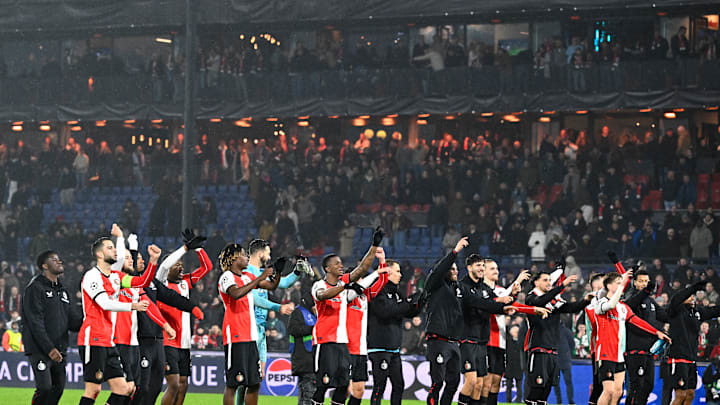 The players and coaches of Feyenoord salute their fans after a famous victory over Bayern Munich.