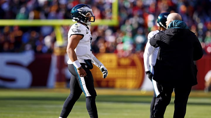 Dec 22, 2024; Landover, Maryland, USA; Philadelphia Eagles quarterback Jalen Hurts (1) walks off the field to leave the game during the first quarter against the Washington Commanders at Northwest Stadium.