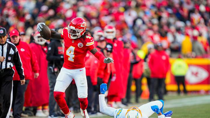 Dec 14, 2025; Kansas City, Missouri, USA; Kansas City Chiefs wide receiver Rashee Rice (4) runs with the ball against Los Angeles Chargers cornerback Benjamin St-Juste (24) during the first half at GEHA Field at Arrowhead Stadium. Mandatory Credit: Jay Biggerstaff-Imagn Images