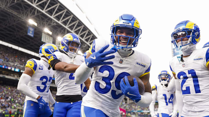 Nov 3, 2024; Seattle, Washington, USA; Los Angeles Rams safety Jaylen McCollough (39) celebrates with teammates, including cornerback Ahkello Witherspoon (4) and cornerback Charles Woods (21) following a first quarter interception against the Seattle Seahawks at Lumen Field. Mandatory Credit: Joe Nicholson-Imagn Images