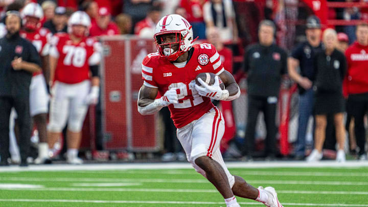 Sep 6, 2025; Lincoln, Nebraska, USA; Nebraska Cornhuskers running back Emmett Johnson (21) runs against the Akron Zips during the second quarter at Memorial Stadium. Mandatory Credit: Dylan Widger-Imagn Images Sep 6, 2025; Lincoln, Nebraska, USA; Nebraska Cornhuskers running back Emmett Johnson (21) runs against the Akron Zips during the second quarter at Memorial Stadium. Mandatory Credit: Dylan Widger-Imagn Images
