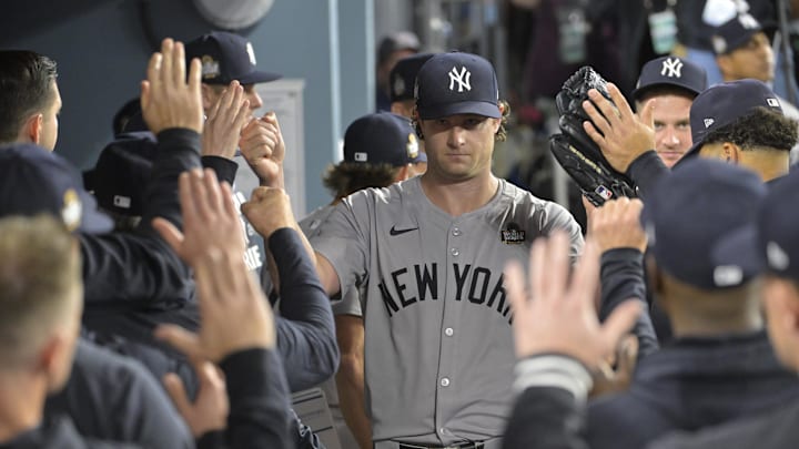 Los Angeles, California, USA; New York Yankees starting pitcher Gerrit Cole (45) receives congratulations in the dugout in the seventh inning against the Los Angeles Dodgers during Game 1 of the 2024 MLB World Series at Dodger Stadium.