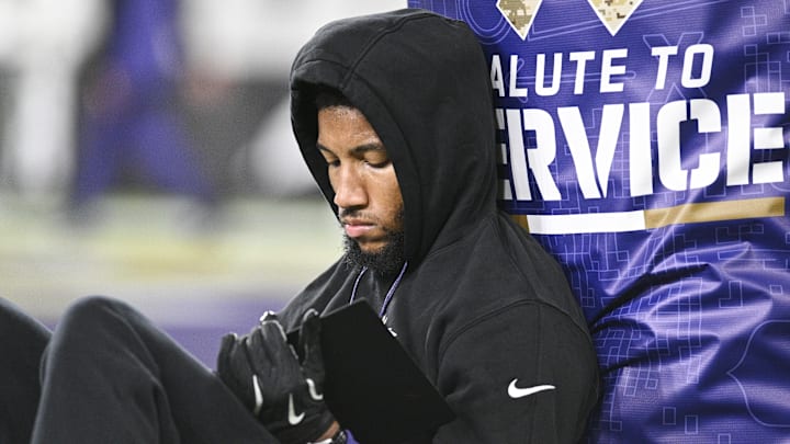 Nov 7, 2024; Baltimore, Maryland, USA;  Baltimore Ravens cornerback Marlon Humphrey (44) sits next to a goal post while looking at a tablet before the game against the Cincinnati Bengals at M&T Bank Stadium. Mandatory Credit: Tommy Gilligan-Imagn Images