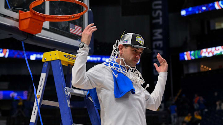 Mar 16, 2025; Nashville, TN, USA;  Florida Gators head coach Todd Golden celebrates the win with cutting down the net against the Tennessee Volunteers at the 2025 SEC Championship Game at Bridgestone Arena. Mandatory Credit: Steve Roberts-Imagn Images