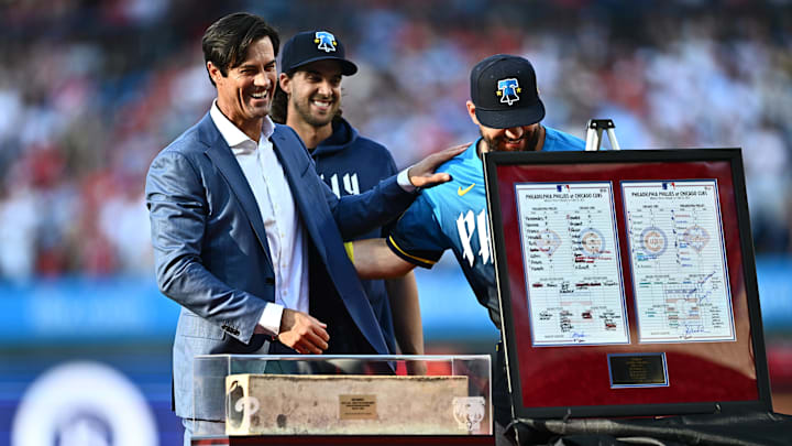 Jun 21, 2024; Philadelphia, Pennsylvania, USA; Former Philadelphia Phillies pitcher Cole Hamels reacts with designated hitter Kyle Schwarber (12) during a ceremony before the game against the Arizona Diamondbacks at Citizens Bank Park. Mandatory Credit: Kyle Ross-Imagn Images