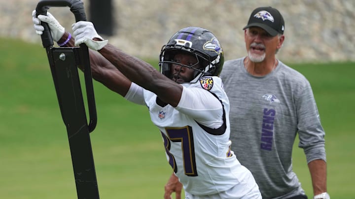 Jul 24, 2025; Owings Mills, MD, USA; Baltimore Ravens coach Chuck Pagano and cornerback Robert Longerbeam (37) work on drills during training camp at the Under Armour Performance Center. Mandatory Credit: Mitch Stringer-Imagn Images