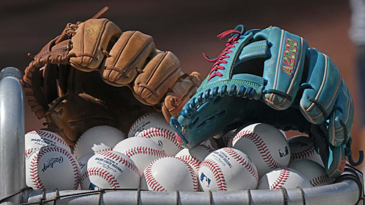 Jun 24, 2025; Kansas City, Missouri, USA;  A general view off baseball gloves and baseballs before a game between the Tampa Bay Rays and Kansas City Royals at Kauffman Stadium. Mandatory Credit: Peter Aiken-Imagn Images