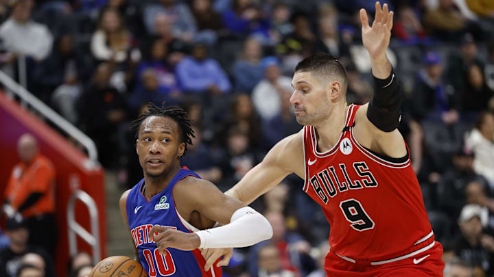 Feb 2, 2025; Detroit, Michigan, USA; Detroit Pistons forward Ronald Holland II (00) dribbles on Chicago Bulls center Nikola Vucevic (9) in the second half at Little Caesars Arena. Mandatory Credit: Rick Osentoski-Imagn Images