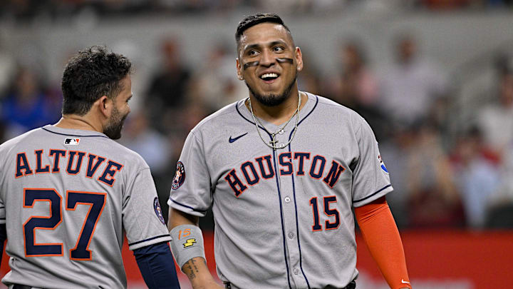 May 16, 2025; Arlington, Texas, USA; Houston Astros second baseman Jose Altuve (27) and third baseman Isaac Paredes (15) smile after scoring against the Texas Rangers during the seventh inning at Globe Life Field. Mandatory Credit: Jerome Miron-Imagn Images