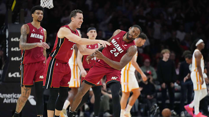 Feb 26, 2025; Miami, Florida, USA;  Miami Heat forward Duncan Robinson (55) playfully pushes forward Haywood Highsmith (24) following his assist on a three-point shot by Robinson that forced a timeout by the Atlanta Hawks in the second half at Kaseya Center. Mandatory Credit: Jim Rassol-Imagn Images