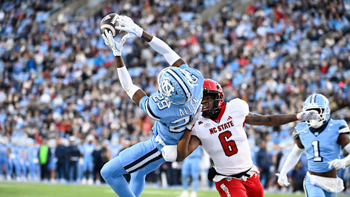 Nov 30, 2024; Chapel Hill, North Carolina, USA; North Carolina Tar Heels defensive back Marcus Allen (29) intercepts the ball in the end zone intended for North Carolina State Wolfpack wide receiver Wesley Grimes (6) in the first quarter at Kenan Memorial Stadium. 
