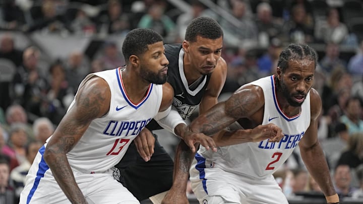 Nov 22, 2023; San Antonio, Texas, USA; Los Angeles Clippers forwards Paul George (13) and Kawhi Leonard (2) box out San Antonio Spurs forward Victor Wembanyama (1) during the second half at Frost Bank Center. Mandatory Credit: Scott Wachter-Imagn Images