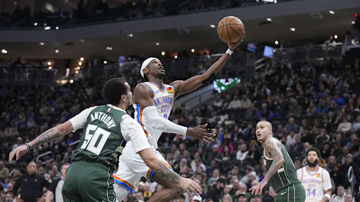 Jan 21, 2026; Milwaukee, Wisconsin, USA; Oklahoma City Thunder guard Shai Gilgeous-Alexander (2) drives to the basket against Milwaukee Bucks guard Cole Anthony (50) and m18/ in the first half at Fiserv Forum. Mandatory Credit: Michael McLoone-Imagn Images