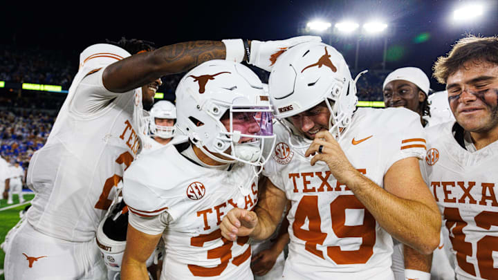 Oct 18, 2025; Lexington, Kentucky, USA; Texas Longhorns wide receiver Jaime Ffrench Jr. (2) and wide receiver Rett Andersen (35) celebrate with kicker Mason Shipley (49) after Shipley scored the winning field goal in overtime against the Kentucky Wildcats at Kroger Field. Mandatory Credit: Jordan Prather-Imagn Images