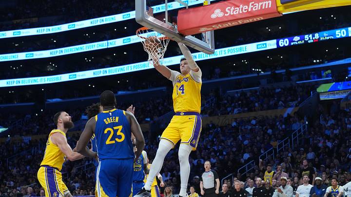 Oct 21, 2026; Los Angeles, California, USA; Los Angeles Lakers center Walker Kessler (14) dunks the ball against Golden State Warriors forward Draymond Green (23) in the first half at Crypto.com Arena. Mandatory Credit: Kirby Lee-Imagn Images