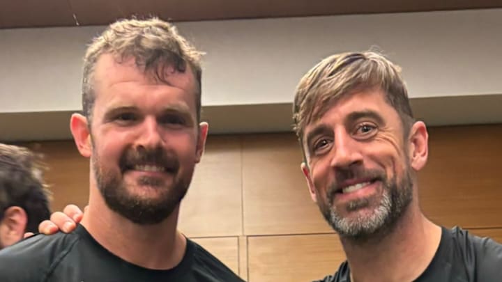 New York Jets punter Thomas Morstead (left) and quarterback Aaron Rodgers (right) pose for a photo in the team's locker room following a 21-13 win over the Houston Texans on October 31, 2024. 