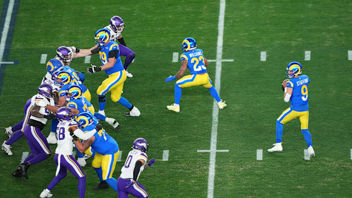 Jan 13, 2025; Glendale, AZ, USA; Los Angeles Rams quarterback Matthew Stafford (9) drops back to pass against the Minnesota Vikings during the first half in an NFC wild card game at State Farm Stadium. Mandatory Credit: Joe Camporeale-Imagn Images Jan 13, 2025; Glendale, AZ, USA; Los Angeles Rams quarterback Matthew Stafford (9) drops back to pass against the Minnesota Vikings during the first half in an NFC wild card game at State Farm Stadium. Mandatory Credit: Joe Camporeale-Imagn Images